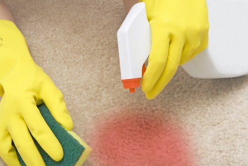 Cleaner removing dust after renovation in a Putney home
